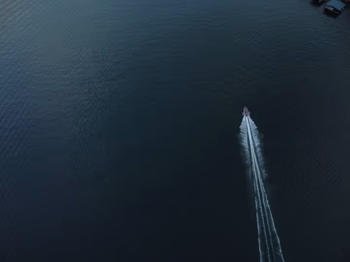 A boat is on the water in the ocean.