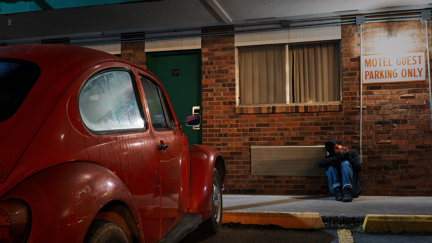 A motel where the lights hum like old prayers.