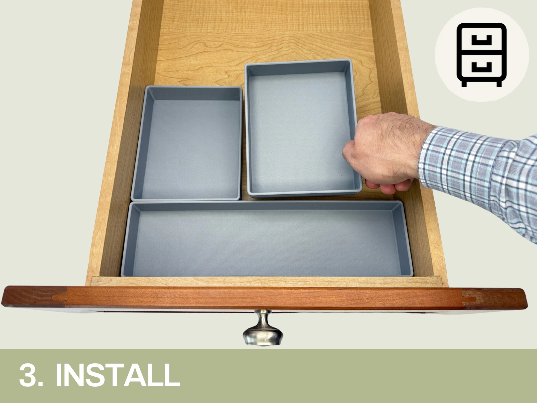 Person placing a gray drawer organizer insert into a wooden drawer, with two other inserts already in place. The image is labeled "3. INSTALL" at the bottom, with an icon of a drawer unit in the top right corner.