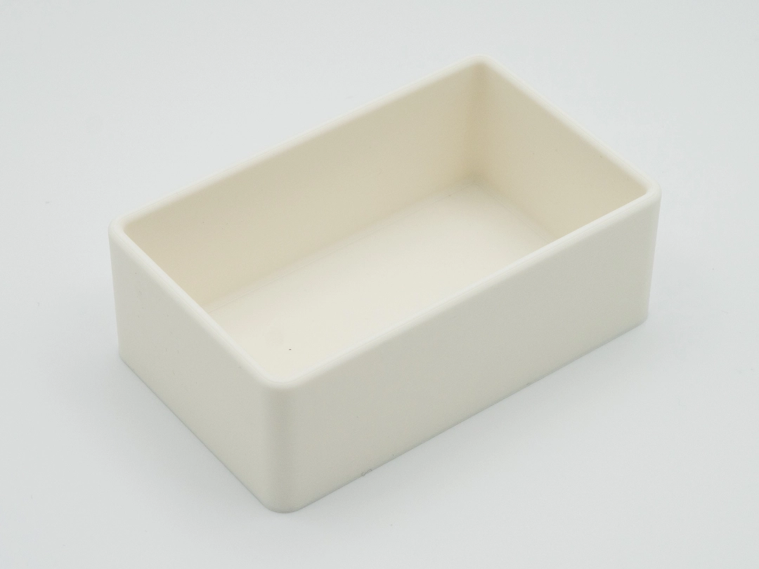 Single empty cream-colored rectangular drawer organizer with rounded inner and outer corners, photographed on a white background.