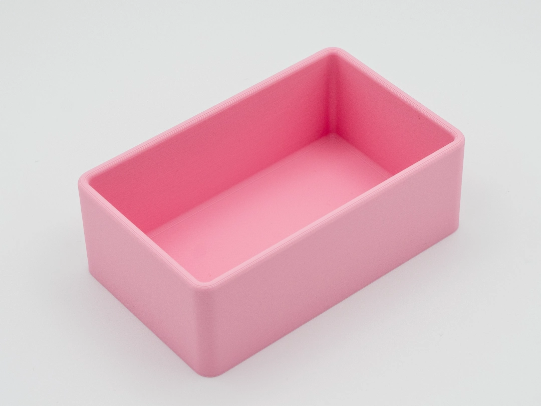 Single empty pink rectangular drawer organizer with rounded corners, shown on a white background.