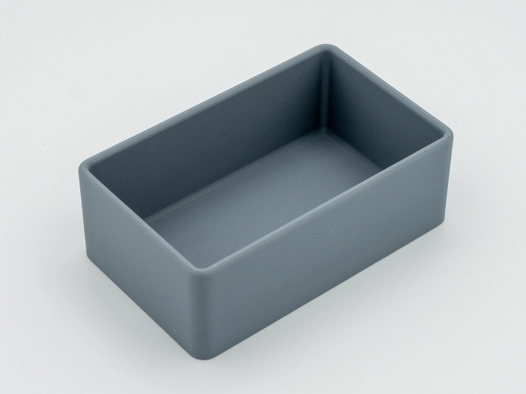 Single empty gray rectangular drawer organizer with rounded corners, shown on a white background.
