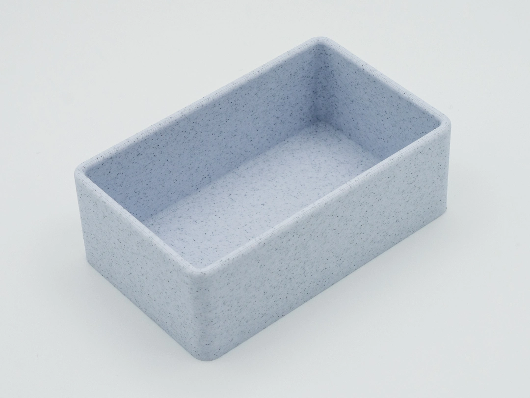 Single empty marble-speckled light gray rectangular drawer organizer with rounded corners, shown on a white background.