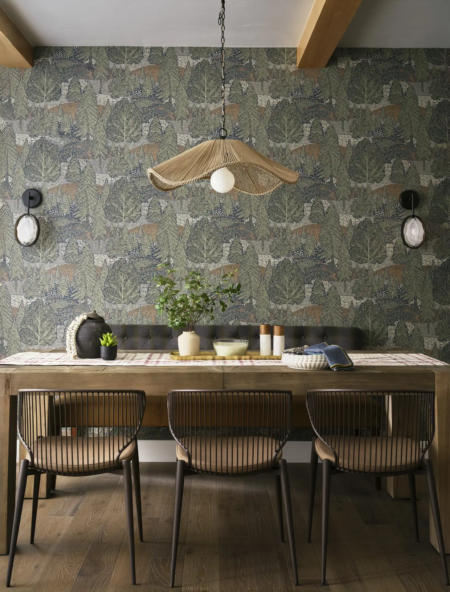 A photograph of a newly remodeled dining room to a Keystone Condo with designer furniture, lighting with a beautiful forest green wallpaper