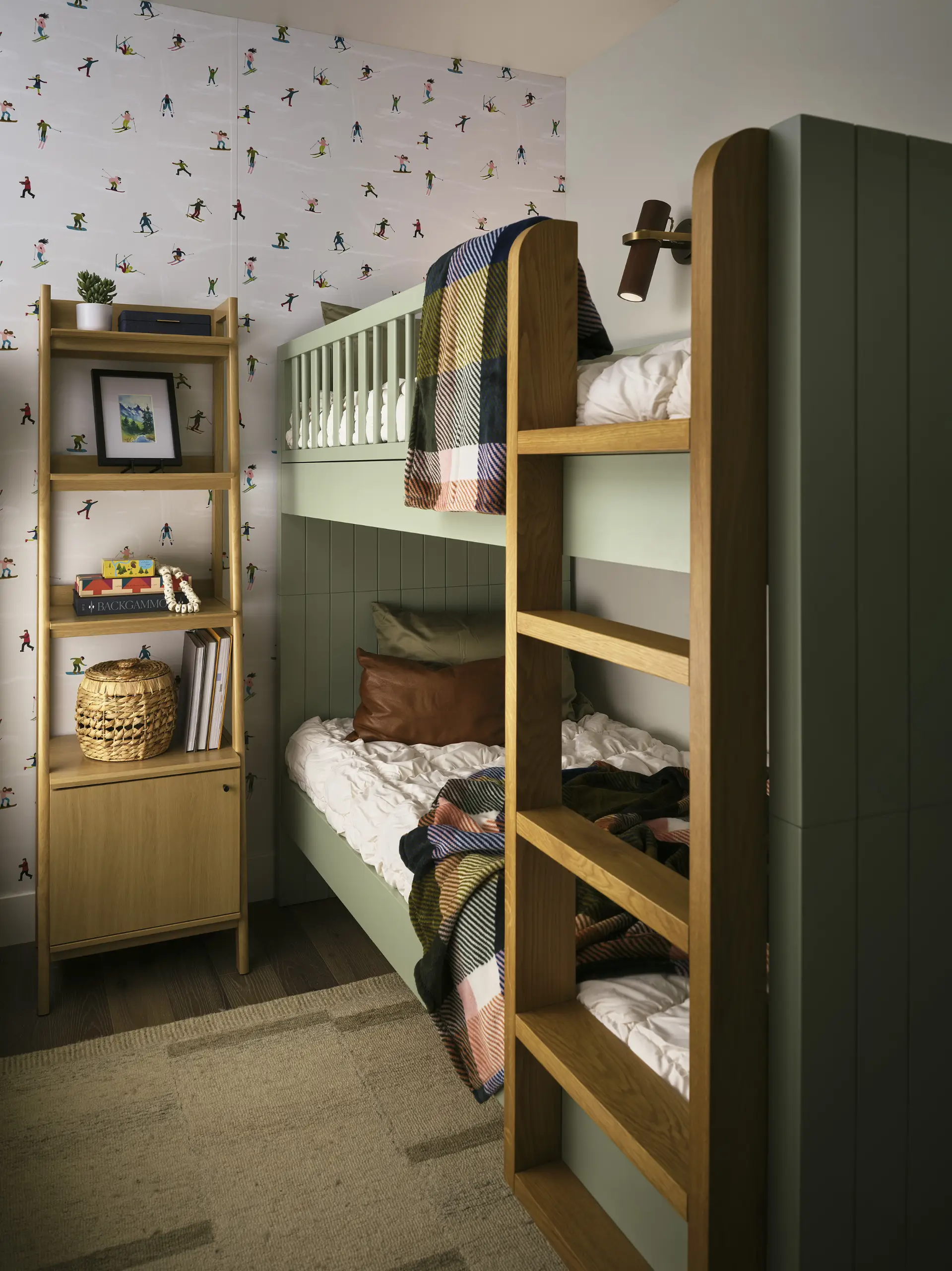A bedroom with built in bunkbeds, ski themed wall paper, and a green themed color palette by Julie Kay Design Studio