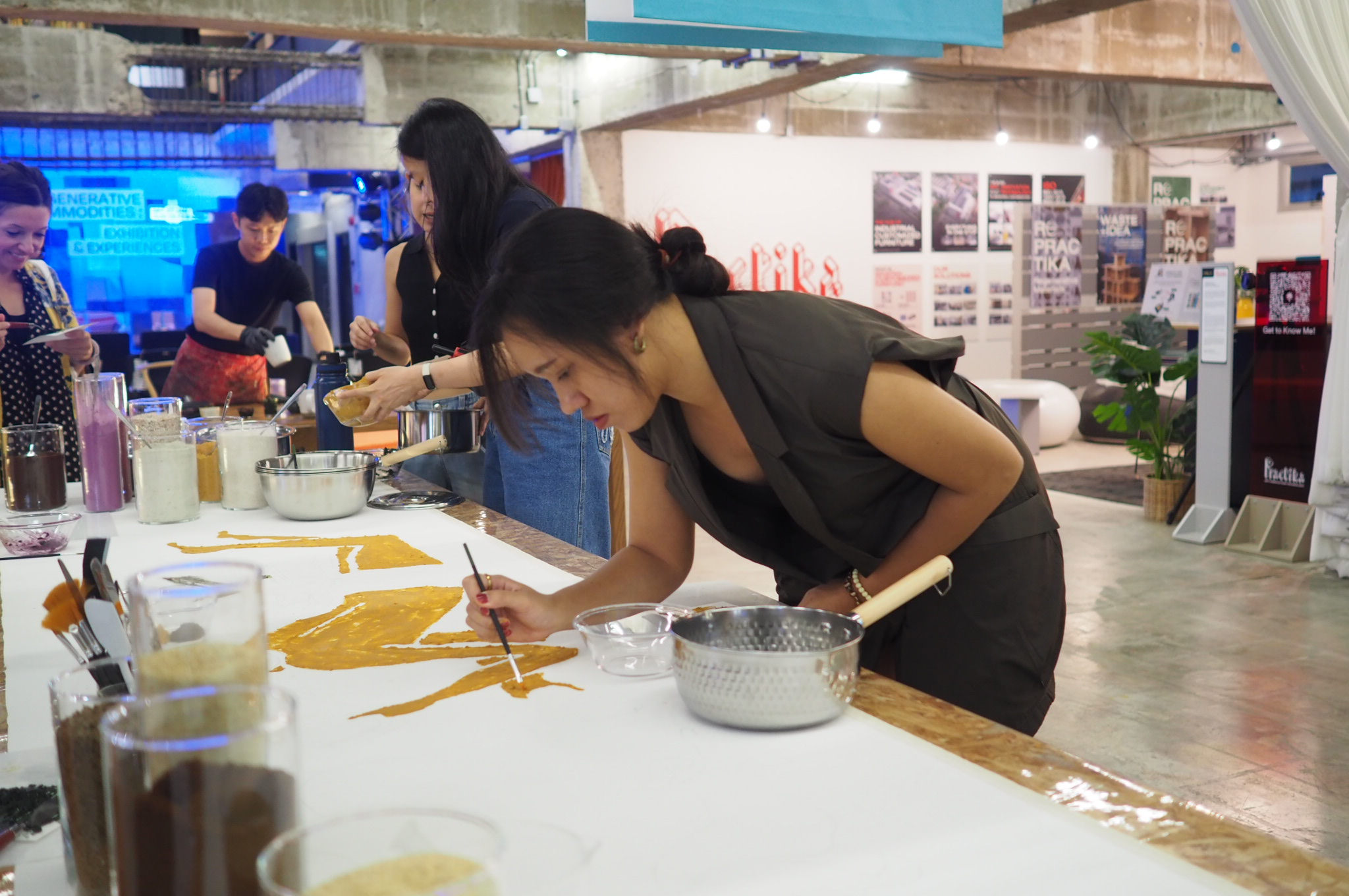 Visitors examining materials at a design exhibition