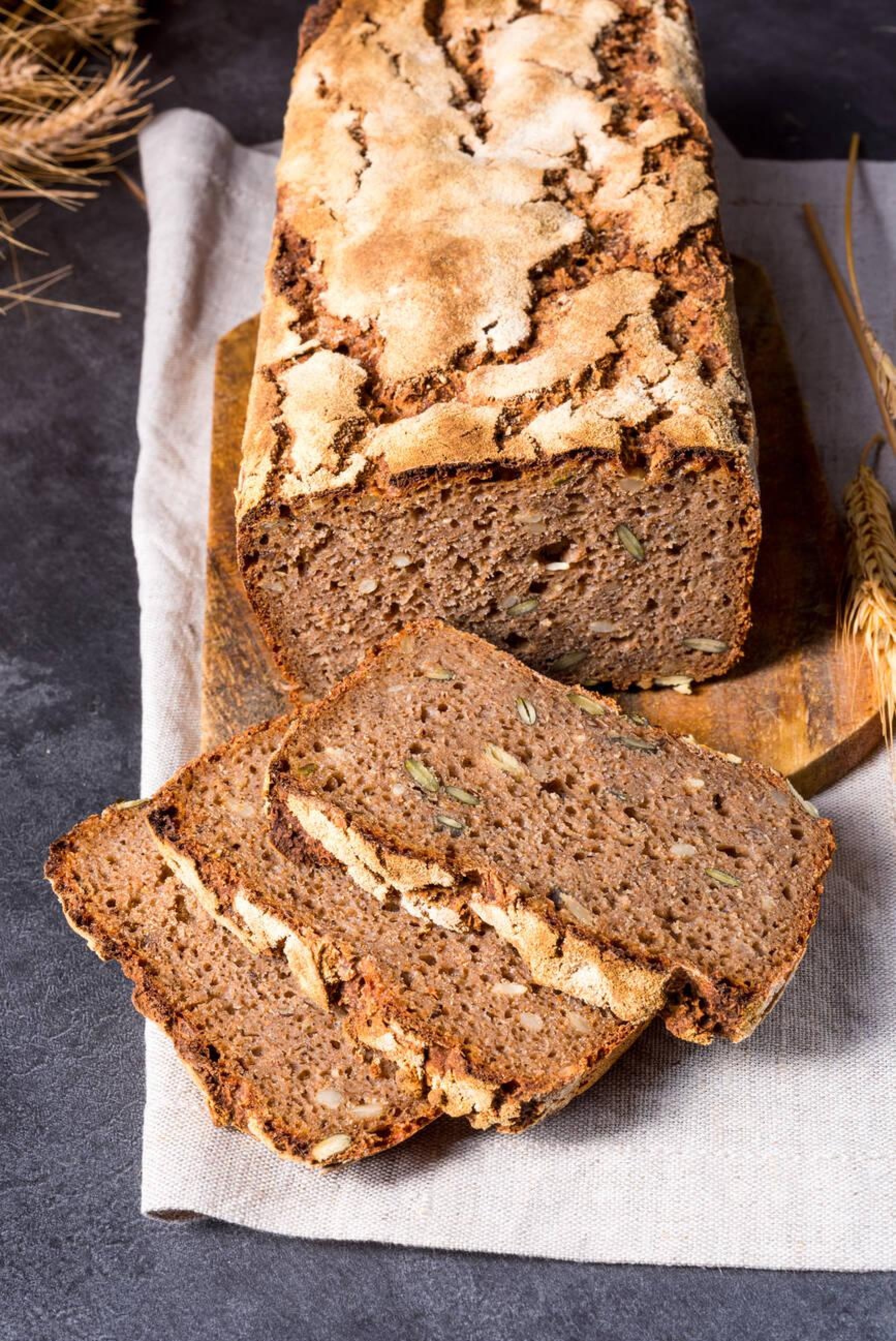 Sliced loaf cake topped with chopped nuts