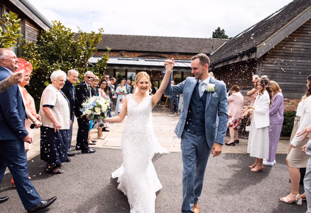 A couple celebrating becoming husband and wife at Mythe Barn