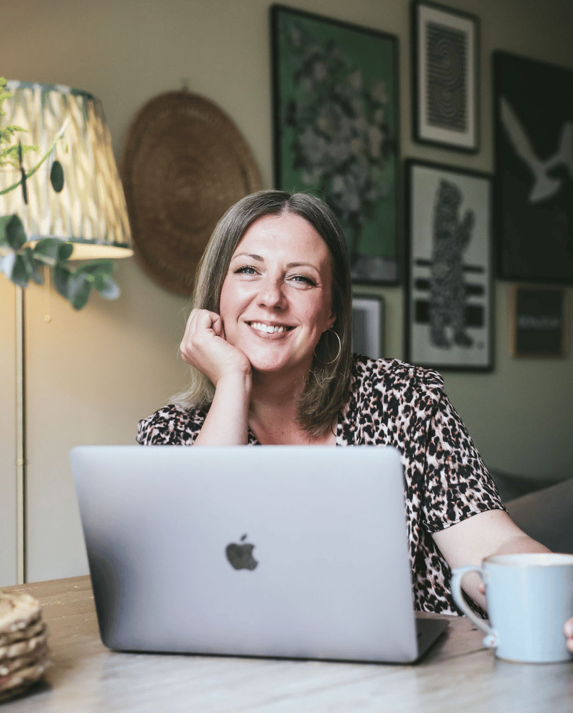 Smiling wedding celebrant wearing a pink suit