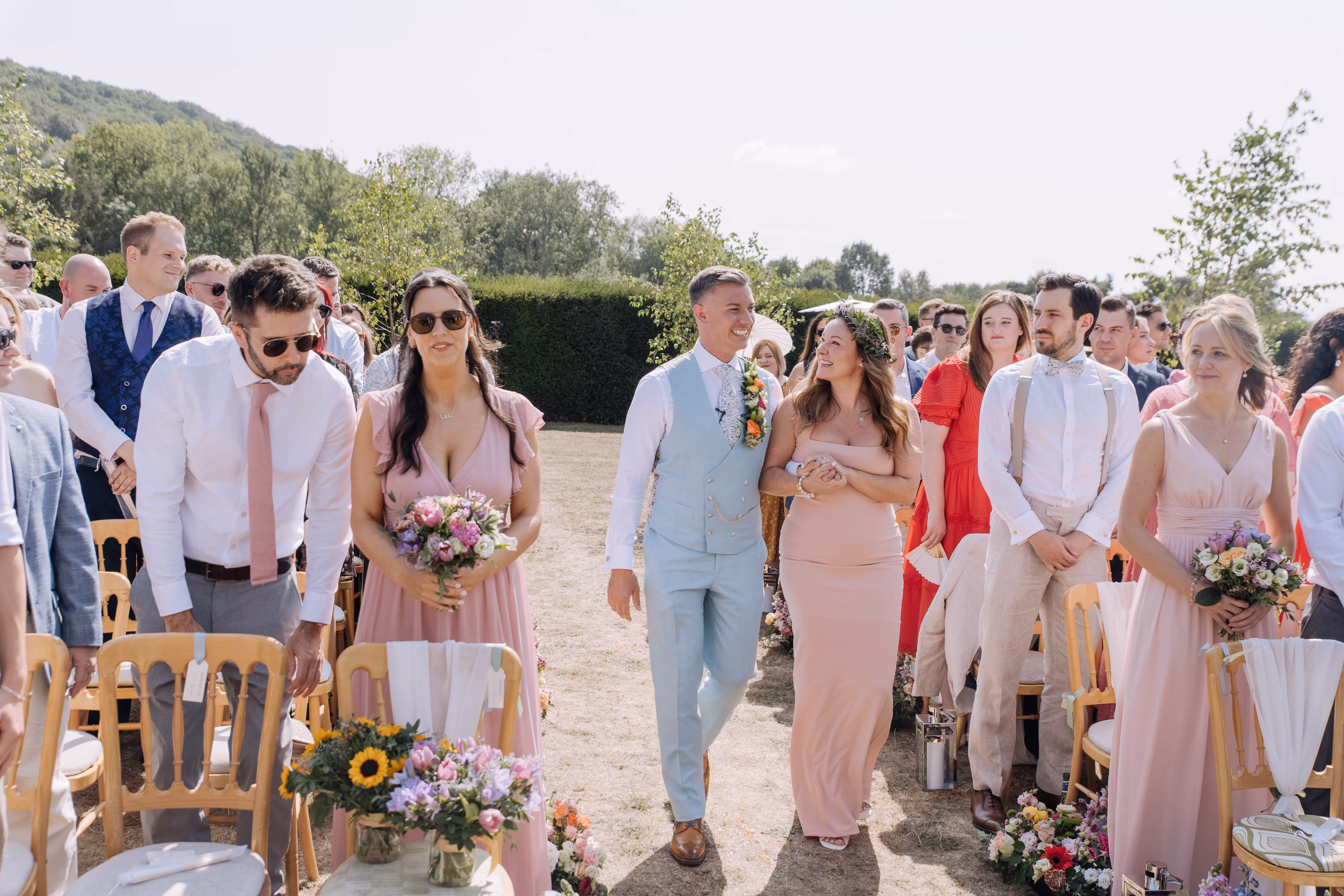 Groom Rod walks down the aisle with guests at Brinsop Court wedding in Hereford.