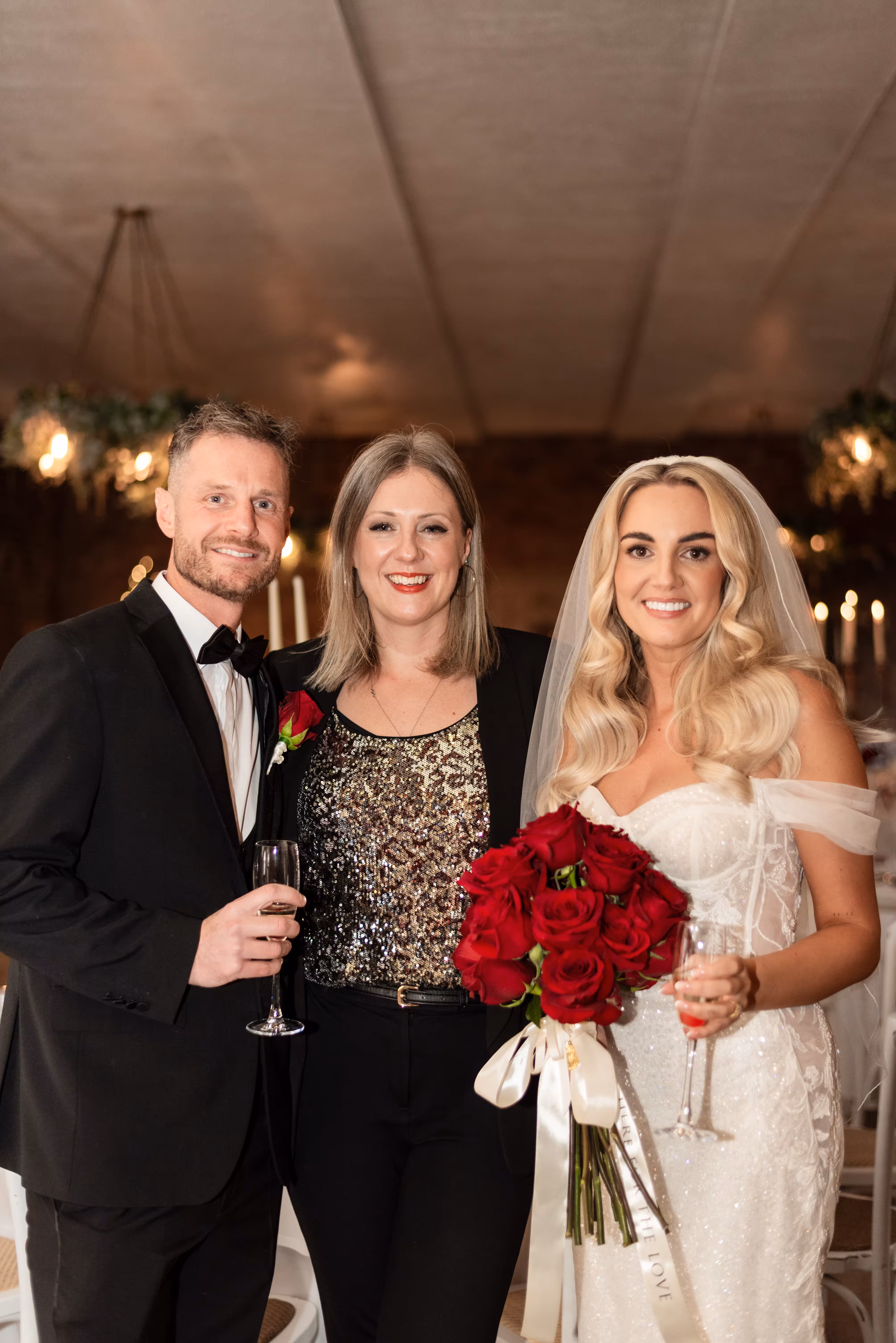 Bride and groom celebrating with Humanist Wedding Celebrant Kate Rostance after their symbolic wedding ceremony at Larkspur Lodge, Cheshire.