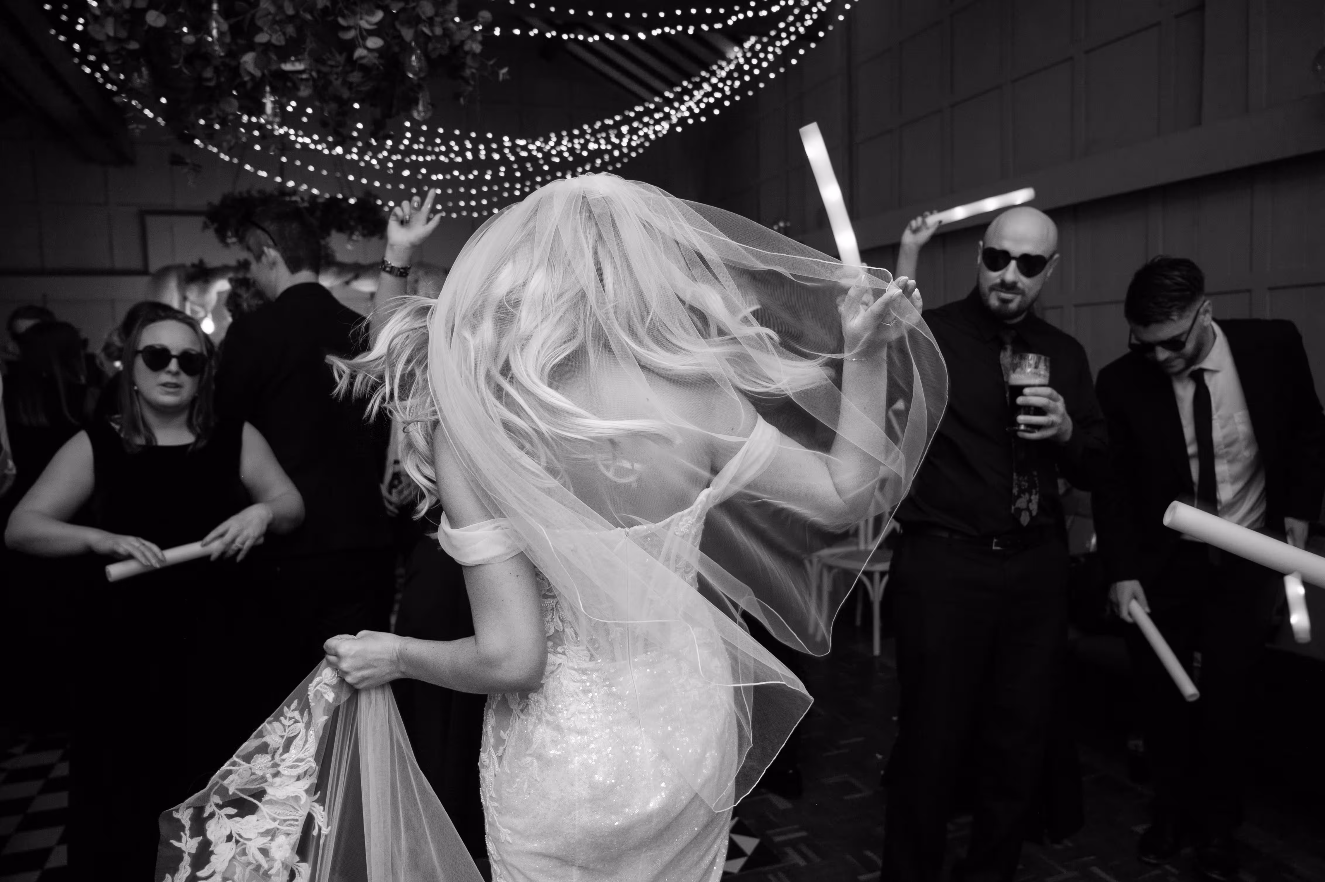 Bride dancing with glow sticks at Larkspur Lodge