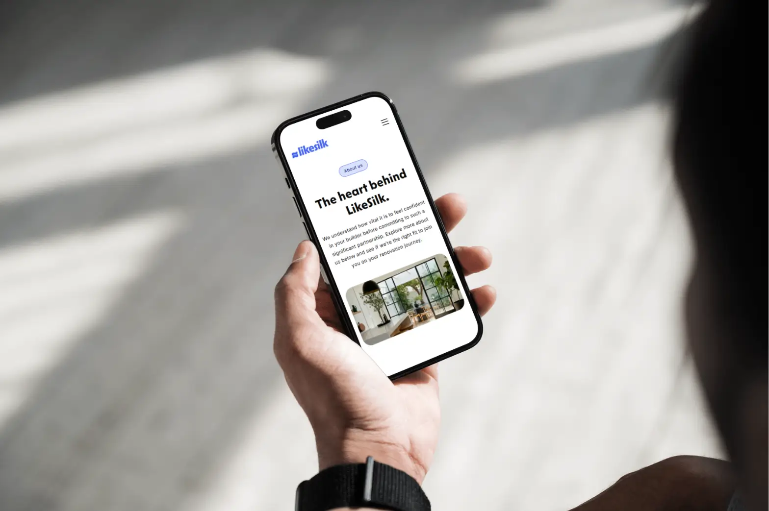 A person looking at the LikeSilk website on their phone