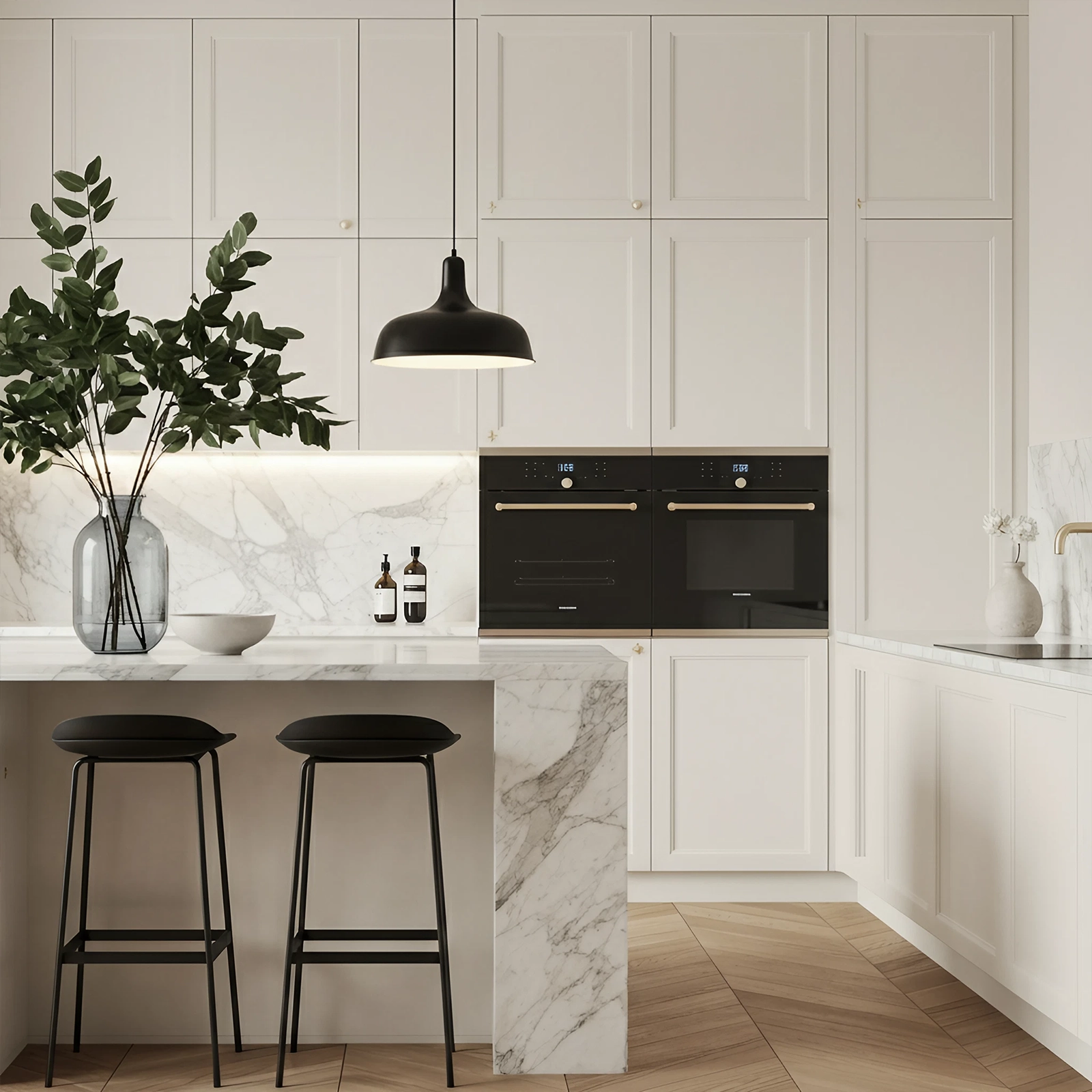 Luxury white kitchen with marble island, black bar stools, and double integrated ovens