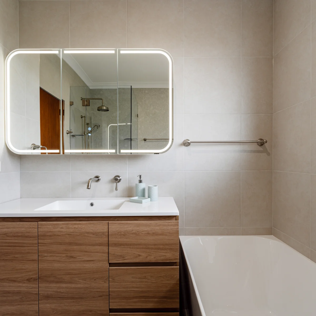 Full bathroom renovation with LED mirror cabinet, timber floating vanity and built-in bathtub