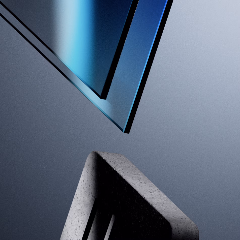 Close-up of a transparent blue glass panel above a textured gray concrete block against a gradient gray background.