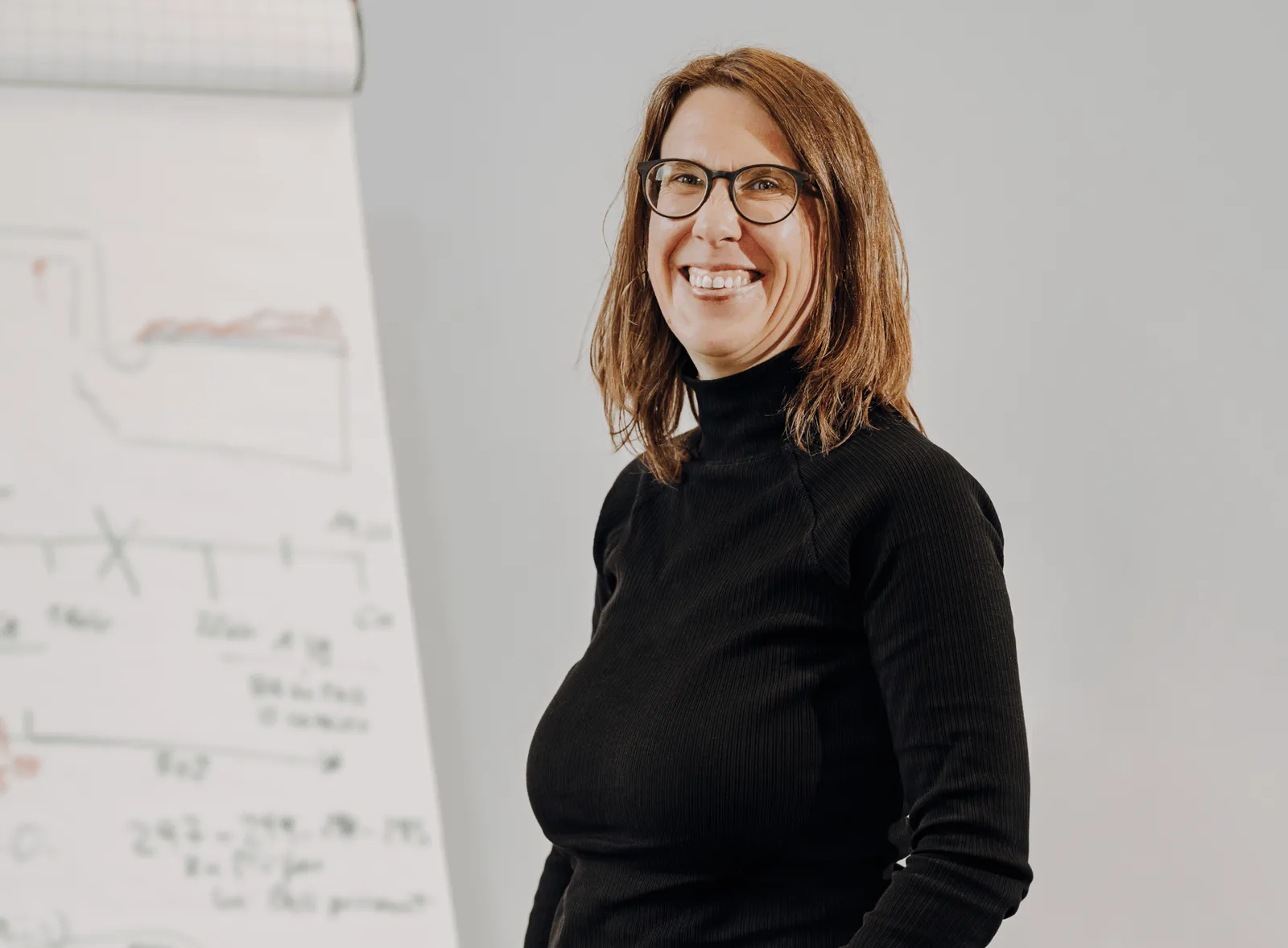A woman standing near clipboard