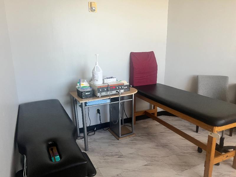 Physical therapist guiding patient through rehabilitation exercises at Complete Care Clinic