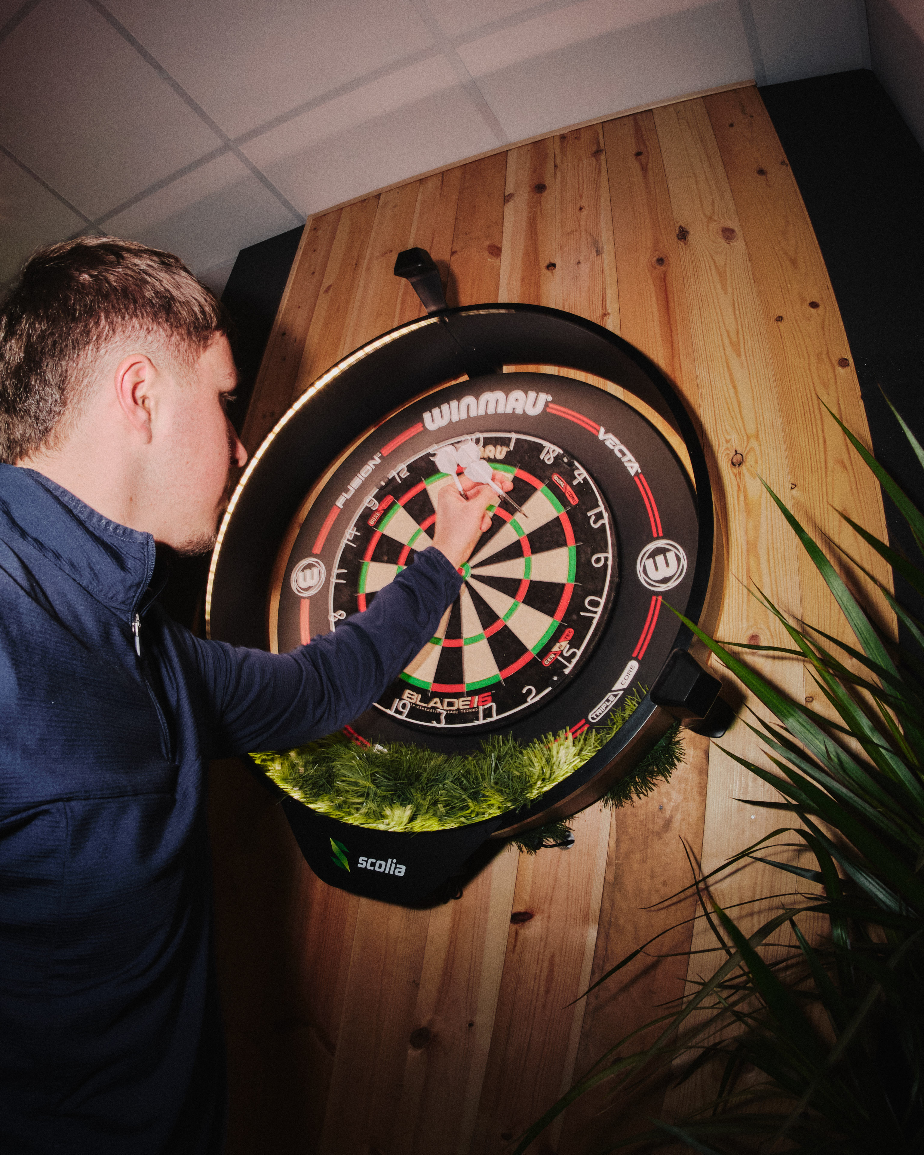 A customer removing their darts from the dartboard