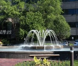water fountain shown in a public park water display pond