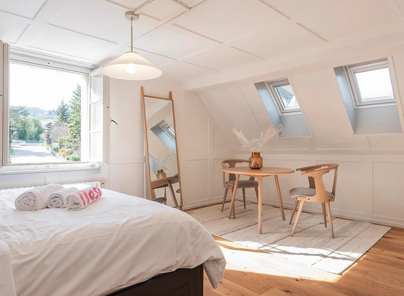 Co-Living Space – room with dormer windows and a small dining table