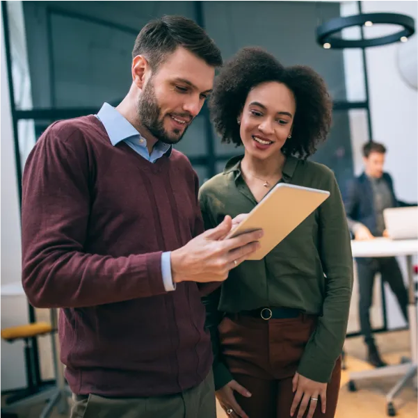 A man and woman looking at something on a clipboard.