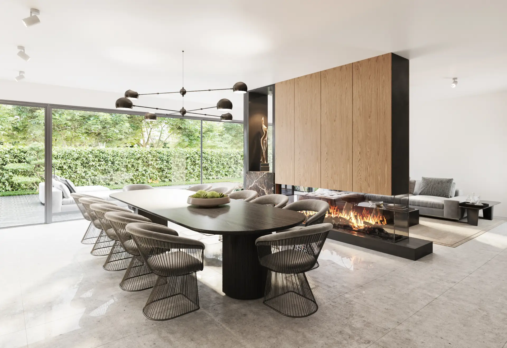 Moderne eetkamer met lange zwarte tafel en metalen stoelen, glazen open haard en grote ramen met uitzicht op groene tuin.