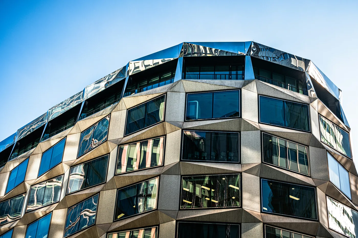 Modern office building with a faceted stone and glass facade