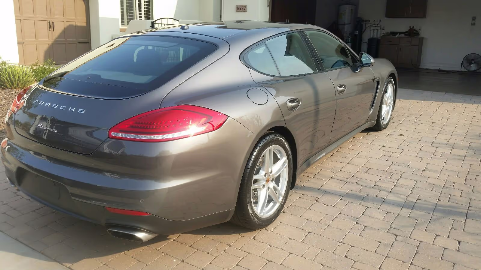 A grey sports car parked in front of a house