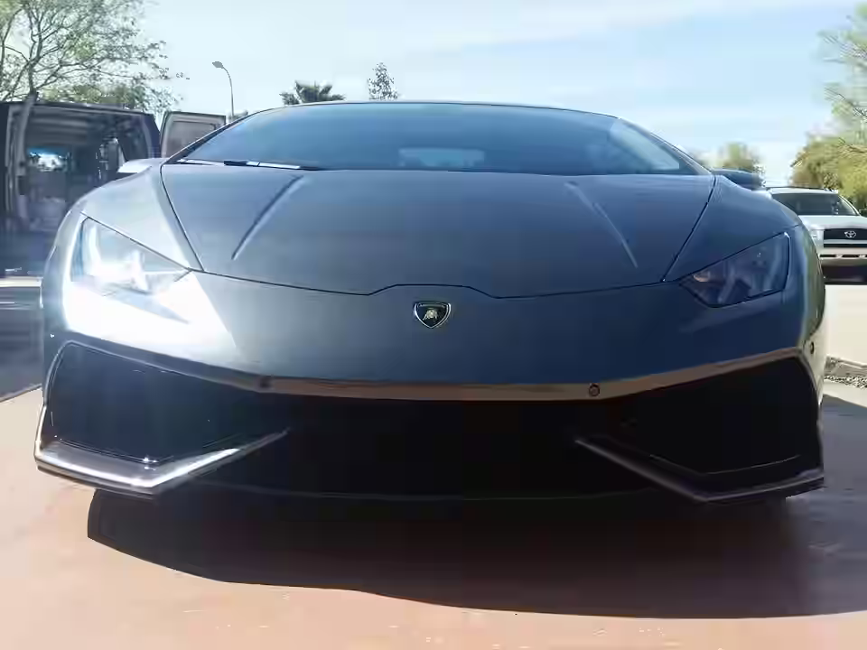 before-and-after of paint correction on a dark-colored car - Full service mobile detailing