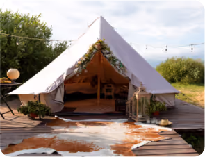 A cozy tent set on a wooden deck, adorned with a stylish cowhide rug