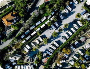 Aerial view of a park filled with numerous motor homes, showcasing green spaces and recreational vehicles 