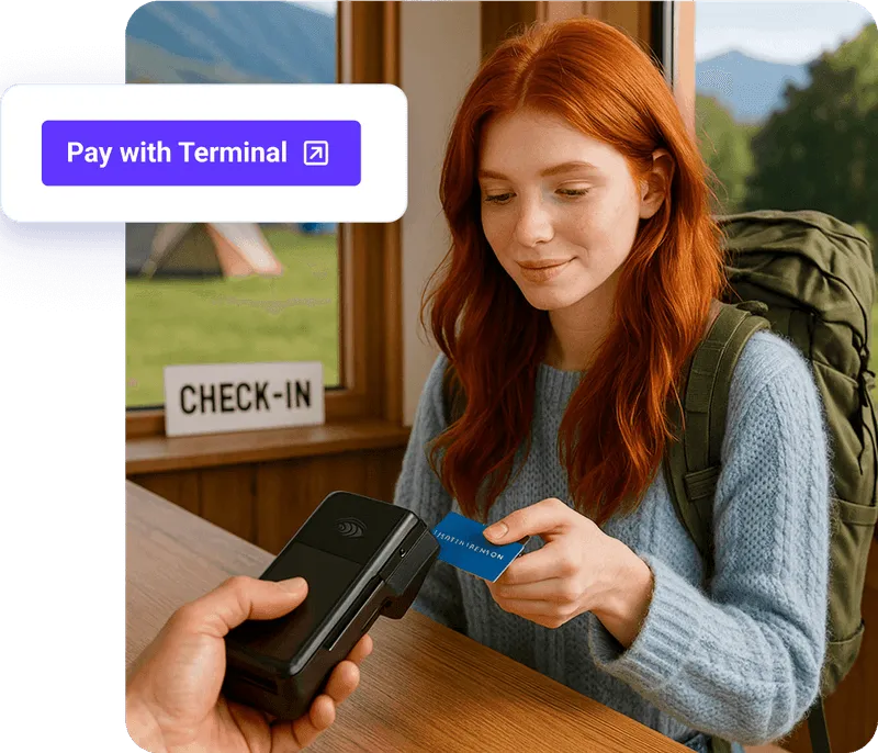 Guest tapping a card on a handheld terminal at check-in.