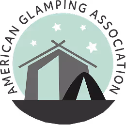 Official circular logo of the American Glamping Association featuring a cabin and tent under a starry sky.