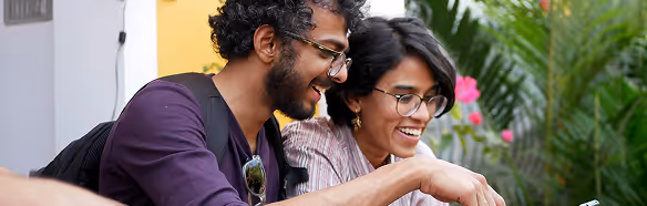 A diverse team of professionals smiling and collaborating on a project, representing personalized support and teamwork.