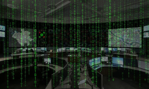 Operators in a control room monitoring real-time system data on a large video wall with visual indicators