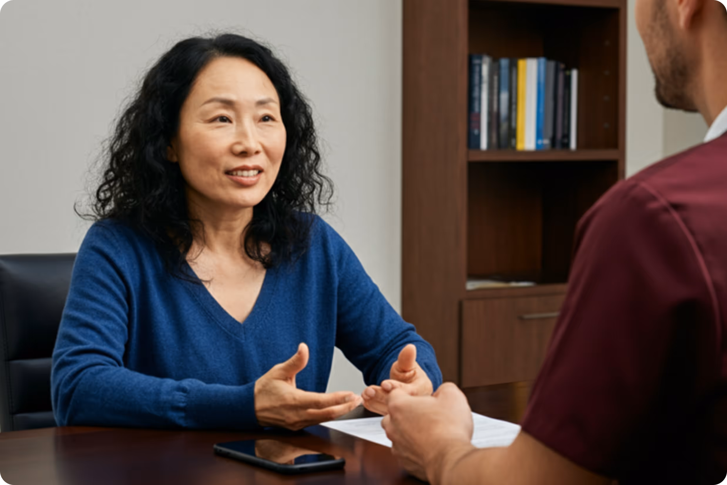 Image of a middle aged woman having a conversation with her doctor