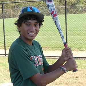 A waist up shot of Elkridge Hurricanes player Ishan Rami in his batting stance looking at the camera.