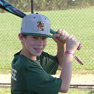 A waist up shot of Elkridge Hurricanes player AJ Calabrese in his batting stance looking at the camera.
