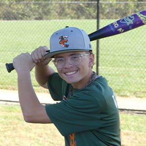 A waist up shot of Elkridge Hurricanes player Connor Wetmore in his batting stance looking at the camera.
