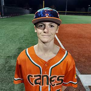 Headshot of Elkridge Hurricanes player Caleb Ireland wearing his orange Canes baseball jersey and green Elkridge E logo hat.