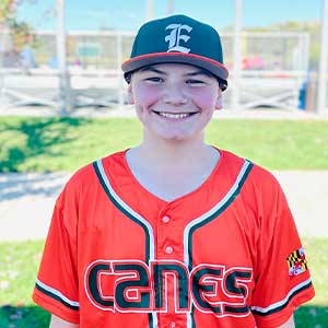 Headshot of Elkridge Hurricanes player Ethan Resnick wearing his orange Canes baseball jersey and green Elkridge E logo hat.