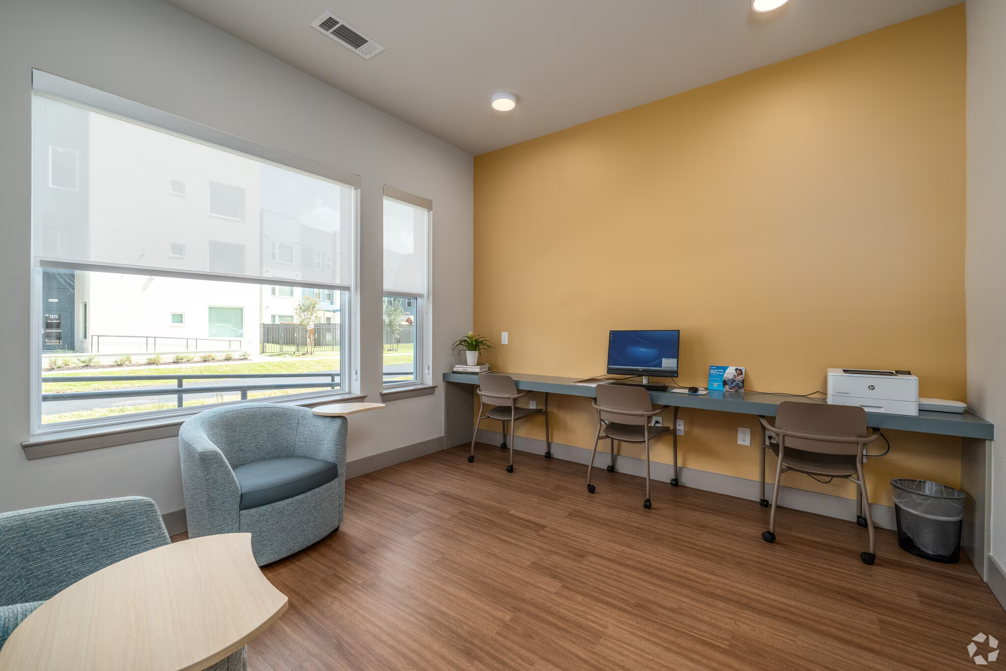 business room with computer, desk, and printer