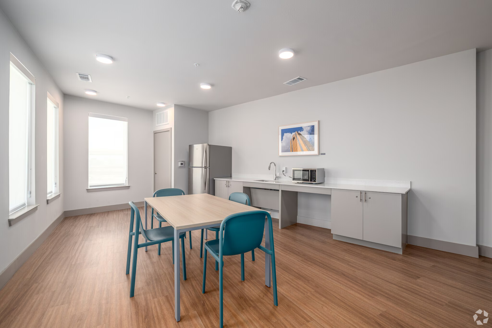 Community Kitchen with table, fridge and microwave