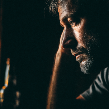 A person contemplating the effects of Suboxone and alcoholism.