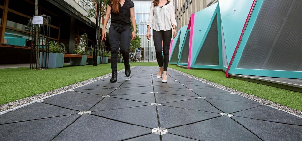 A pair of women walking on a sidewalkAI-generated content may be incorrect.