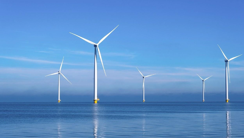 Several wind turbines in the oceanAI-generated content may be incorrect.