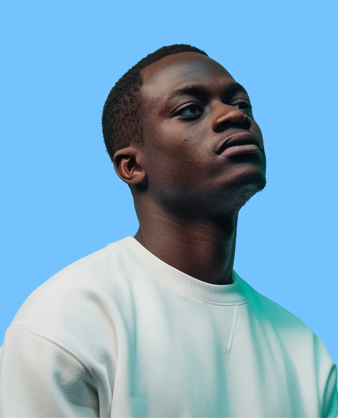 A man in a white shirt looking up.
