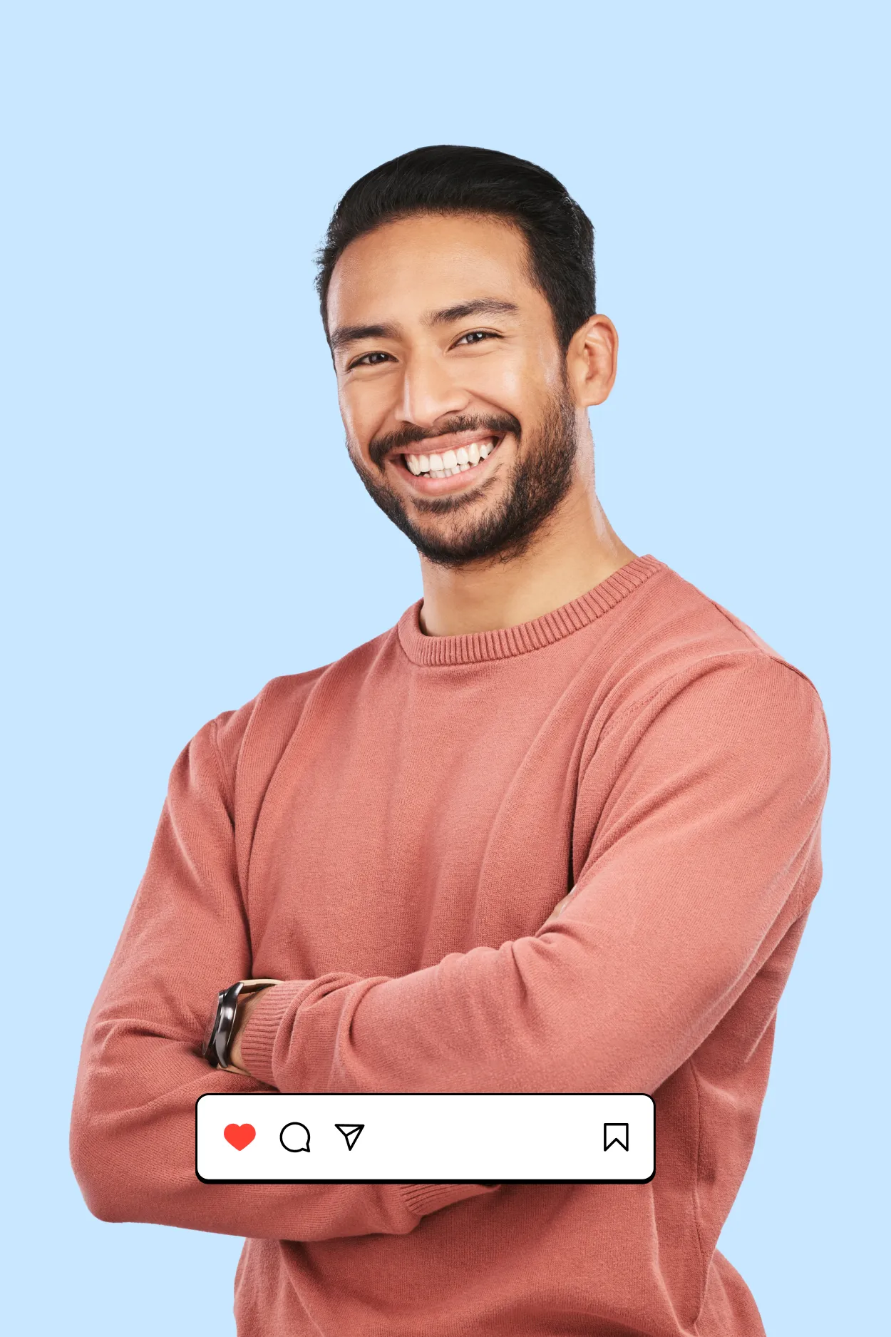 A smiling man with his arms crossed in front of a blue background.