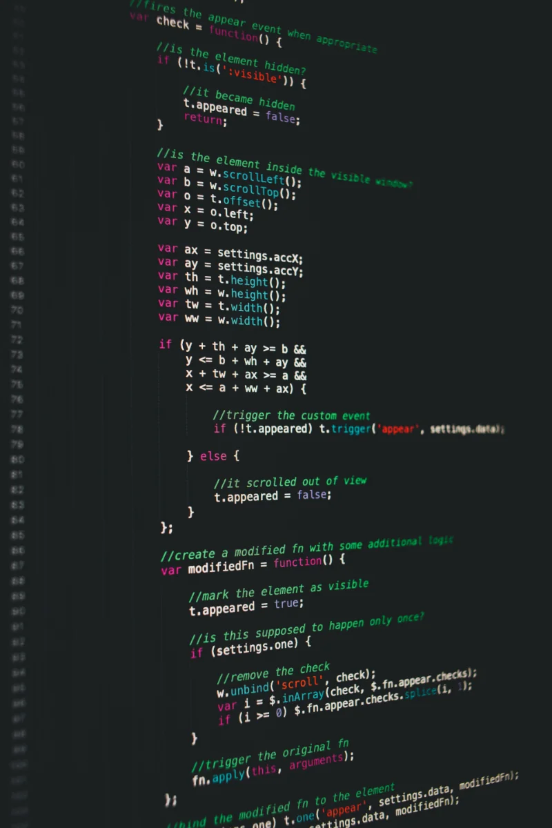 Close-up of colorful JavaScript code on a dark screen showing functions and conditional statements.